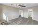 A bright bedroom features wood flooring, a ceiling fan, a walk-in closet and a bathroom access at 58 Desert Castle Ct, Henderson, NV 89012