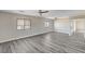 Large bedroom with gray wood-look floors, neutral paint, fan and plenty of windows at 58 Desert Castle Ct, Henderson, NV 89012