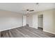 A bright bedroom features wood flooring, a ceiling fan, a walk-in closet and a bathroom access at 58 Desert Castle Ct, Henderson, NV 89012