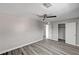 Spacious bedroom with wood floors, a ceiling fan, and doorways to other rooms at 58 Desert Castle Ct, Henderson, NV 89012