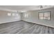 Spacious primary bedroom with wood-look floors, large windows, and neutral walls for relaxation at 58 Desert Castle Ct, Henderson, NV 89012