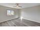 A bright bedroom features wood flooring, a window with natural light and neutral colored walls at 58 Desert Castle Ct, Henderson, NV 89012
