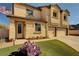 Beautiful stucco home with a two-car garage, green lawn, and desert landscaping at 58 Desert Castle Ct, Henderson, NV 89012