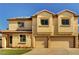 Two-story stucco home featuring a two-car garage, well-maintained lawn, and a classic desert landscape at 58 Desert Castle Ct, Henderson, NV 89012