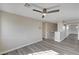 Upstairs hallway with wood-look floors, neutral paint, ceiling fan, and access to multiple rooms at 58 Desert Castle Ct, Henderson, NV 89012