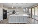 Bright kitchen with a large island, stainless steel appliances, modern pendant lighting, and a slider to the back yard at 58 Desert Castle Ct, Henderson, NV 89012