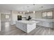 Open kitchen featuring a large island with pendant lighting, stainless appliances, and access to living spaces at 58 Desert Castle Ct, Henderson, NV 89012