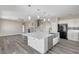 Open kitchen featuring a large island, stainless steel appliances, and seamless flow into the living spaces at 58 Desert Castle Ct, Henderson, NV 89012