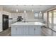 Bright kitchen with a large island, stainless steel appliances, modern pendant lighting, and a slider to the back yard at 58 Desert Castle Ct, Henderson, NV 89012