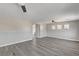 Spacious living area with gray wood floors, light-colored walls, and a view of the bathroom at 58 Desert Castle Ct, Henderson, NV 89012