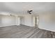 Bright living room with gray wood floors, ceiling fans, and white trim and doors at 58 Desert Castle Ct, Henderson, NV 89012