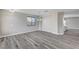 Bright living room featuring modern gray wood floors, neutral walls, and modern lighting fixture at 58 Desert Castle Ct, Henderson, NV 89012
