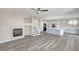 Open-concept floor plan featuring wood-look floors, a fireplace, a staircase, and a kitchen with an island at 58 Desert Castle Ct, Henderson, NV 89012