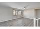 Bright, airy loft area with wood-look floors, a ceiling fan, and great natural light from large windows at 58 Desert Castle Ct, Henderson, NV 89012