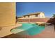 In-ground pool with attached spa in a fenced backyard next to the home at 58 Desert Castle Ct, Henderson, NV 89012