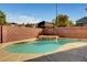 Sparkling in-ground pool and relaxing spa in private backyard with brick wall at 58 Desert Castle Ct, Henderson, NV 89012