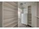 Organized white walk-in closet with shelving and drawers for ample storage space at 58 Desert Castle Ct, Henderson, NV 89012
