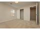 A comfy bedroom featuring neutral-colored walls, carpet, a closet, and natural light from a window with blinds at 6609 Pine Siskin Pl, North Las Vegas, NV 89084