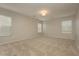 A large, carpeted bedroom with neutral-colored walls and three windows at 6609 Pine Siskin Pl, North Las Vegas, NV 89084