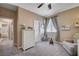 Cozy Bedroom with a gray rocking chair, white dresser, soft carpet, and natural light from the window at 7195 Morningside Ranch Ct, Las Vegas, NV 89113