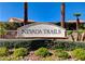 Nevada Trails community entrance sign framed by palm trees and lush greenery at 7195 Morningside Ranch Ct, Las Vegas, NV 89113