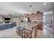 Bright open concept kitchen with stainless steel appliances, granite countertops, and seating for three at 7195 Morningside Ranch Ct, Las Vegas, NV 89113