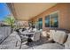 Relaxing covered patio featuring a dining set, outdoor seating, and a barbecue for entertaining guests at 7195 Morningside Ranch Ct, Las Vegas, NV 89113