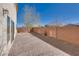 The backyard showcases a brick-paved patio, rock landscaping, and a brick perimeter wall for privacy at 7203 Pepperbox Ave, Las Vegas, NV 89179