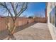 A desert landscaped backyard with a brick patio and a sturdy shade tree at 7203 Pepperbox Ave, Las Vegas, NV 89179