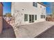 Backyard features a brick-paved patio, rock landscaping, and a stucco exterior with sliding glass doors at 7203 Pepperbox Ave, Las Vegas, NV 89179