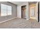 Bedroom featuring carpet, natural light, closet and a partial view into the hall at 7203 Pepperbox Ave, Las Vegas, NV 89179