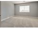 Neutral bedroom with carpeted floor, base trim, and a window at 7203 Pepperbox Ave, Las Vegas, NV 89179