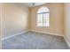Bright bedroom features a neutral color scheme, plush carpeting and an arched window at 7203 Pepperbox Ave, Las Vegas, NV 89179