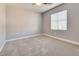 Carpeted bedroom with neutral paint, base trim and a window at 7203 Pepperbox Ave, Las Vegas, NV 89179