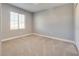 Carpeted bedroom with neutral paint, base trim and a window at 7203 Pepperbox Ave, Las Vegas, NV 89179