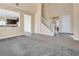 Bright open floor plan featuring a stairway, front door, and an eat in kitchen with dark cabinetry at 7203 Pepperbox Ave, Las Vegas, NV 89179
