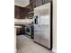 Kitchen featuring stainless steel refrigerator and appliances, dark cabinets and gray countertops at 7203 Pepperbox Ave, Las Vegas, NV 89179