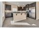 Kitchen featuring stainless steel appliances, dark cabinetry, an island, recessed lighting and tile floors at 7203 Pepperbox Ave, Las Vegas, NV 89179