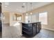 Bright kitchen with tile flooring, a center island, stainless steel appliances and natural light at 7203 Pepperbox Ave, Las Vegas, NV 89179