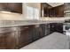 Kitchen with dark cabinets, stainless steel appliances, gray countertops, and tile flooring at 7203 Pepperbox Ave, Las Vegas, NV 89179