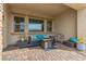 Comfortable covered patio featuring wicker furniture, a coffee table, and decorative cushions for relaxing outdoor living at 746 Purple Knoll Walk, Henderson, NV 89011