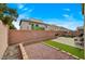 Large, private backyard with hardscape, green space, and a brick perimeter, ideal for outdoor activities at 7856 Pyramid Peak St, Las Vegas, NV 89166