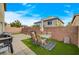 Paver patio features artificial turf, a dining set, and barbecue areas in a private backyard setting at 7856 Pyramid Peak St, Las Vegas, NV 89166