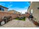 Backyard includes brick pavers, artificial turf area with dining set, and a barbecue grill at 7856 Pyramid Peak St, Las Vegas, NV 89166