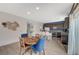Open dining area with wood table, blue chairs, and a view of the kitchen with stainless steel appliances at 7856 Pyramid Peak St, Las Vegas, NV 89166