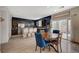Bright dining area with modern table, backyard access, and an open view of the kitchen at 7856 Pyramid Peak St, Las Vegas, NV 89166