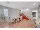 Bright dining room with wood floors, natural light, and stairs leading up to the next level at 7856 Pyramid Peak St, Las Vegas, NV 89166