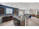 A modern, spacious kitchen features an island, granite countertops, and stainless steel appliances at 7856 Pyramid Peak St, Las Vegas, NV 89166