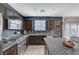 Contemporary kitchen features stainless appliances, granite counters, and a view to the yard at 7856 Pyramid Peak St, Las Vegas, NV 89166