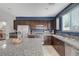 Spacious kitchen with stainless steel appliances, granite countertops, dark wood cabinets, and a kitchen island at 7856 Pyramid Peak St, Las Vegas, NV 89166